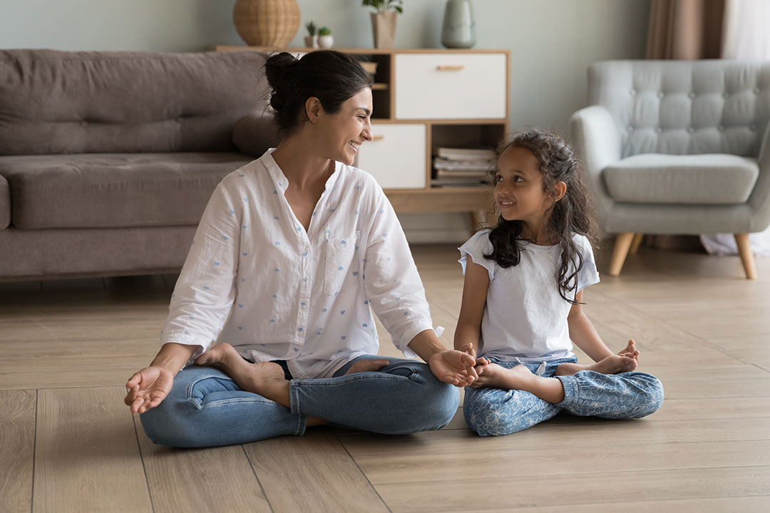 A mother and daughter doing yoga